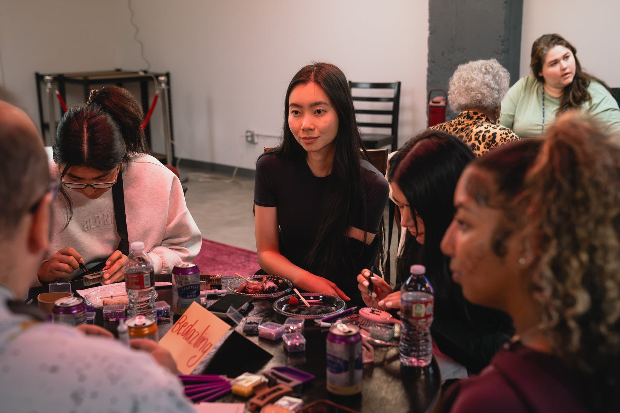 Friends crafting together around a table at Poppy House
